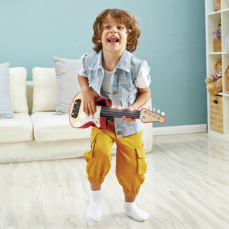 Hape leuchtende Leder-Ukulele rot – Spielzeug-Musikinstrument für Kinder ab 3 Jahren
